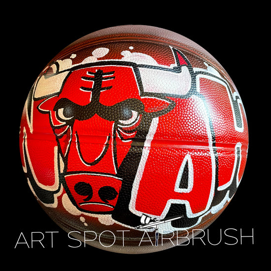 Personalized Basketball with a name in red and black painted in custom airbrush graffiti with a bull design in the name