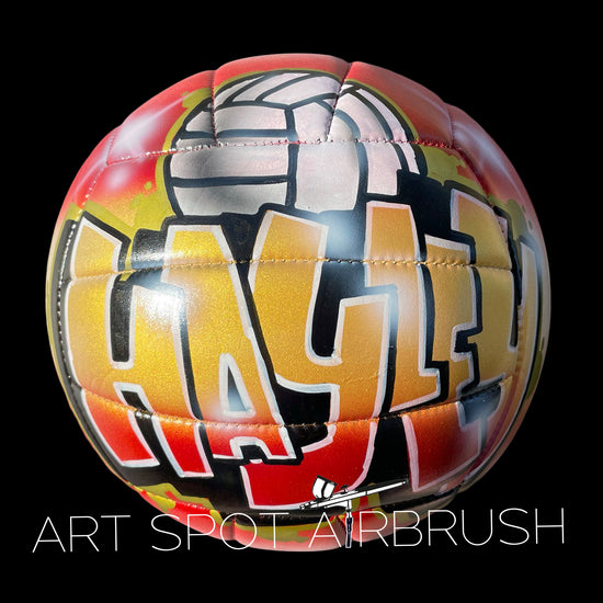 Personalized volleyball with a name painted in custom airbrush graffiti with a volleyball design on top of the name.